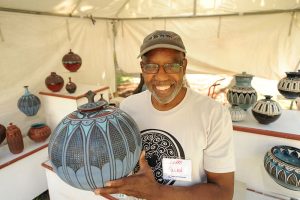 Larry Allen shows off his pottery work